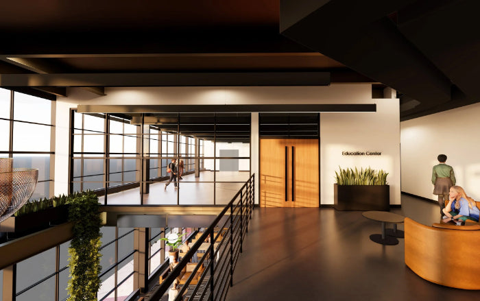 A modern interior architectural rendering of a multi-level office lobby with glass walls, dark wood flooring, a curved reception desk, and a sign reading 'Education Center'. Northlight theatre.